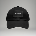 Black cap with 'RZLVD' logo on a gray background