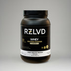 Black protein powder container with RZLVD branding on a gray background